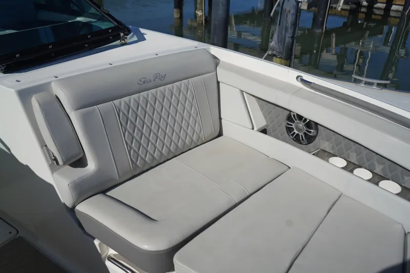 Slide: The Image of 2023 Sea Ray SLX 350 boat interior with luxurious seating and speaker system. - 10