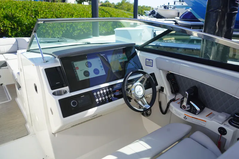 Slide: The Image of 2023 Sea Ray SLX 350 helm with advanced controls and touchscreen display. - 13