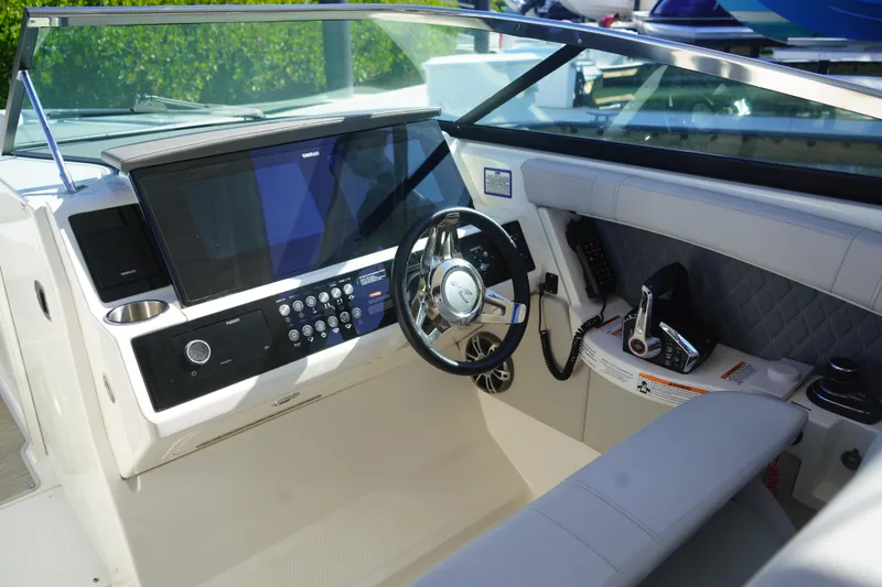 Slide: The Image of 2023 Sea Ray SLX 350 helm with modern controls and navigation display. - 14