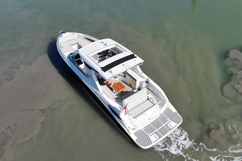 Slide: The Image of 2023 Sea Ray SLX 350 luxury boat cruising on calm waters, aerial view. - 5