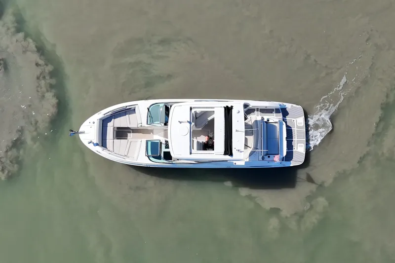 Slide: The Image of Aerial view of 2023 Sea Ray SLX 350 boat cruising in clear water. - 6