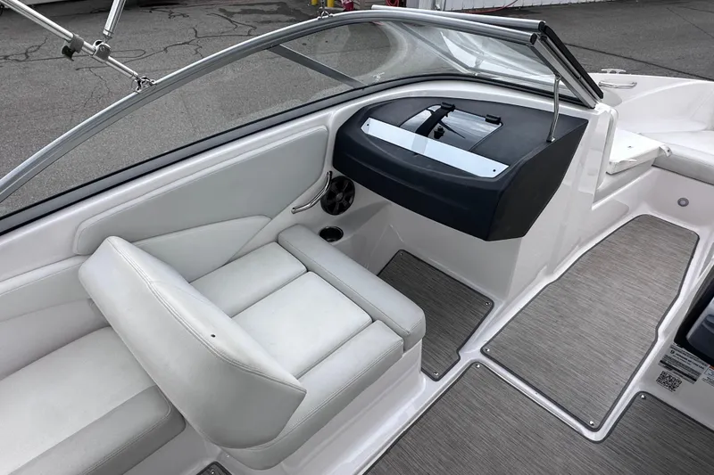 Slide: The Image of 2018 Regal 1900 ES Bowrider interior with white seating and sleek dashboard design. - 13
