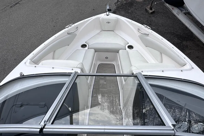 Slide: The Image of 2018 Regal 1900 ES Bowrider boat with white seating and open windshield. - 17