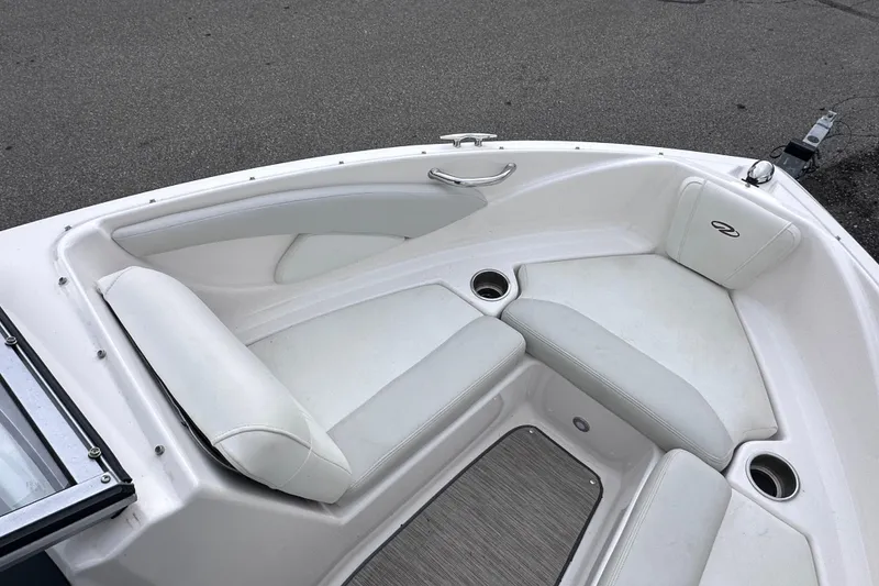 Slide: The Image of 2018 Regal 1900 ES Bowrider boat interior with white seating and cup holders. - 18