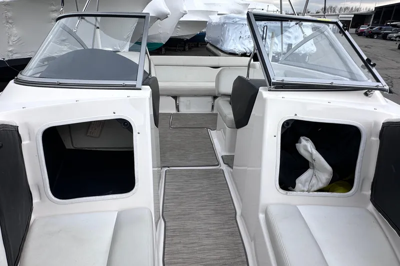 Slide: The Image of 2018 Regal 1900 ES Bowrider interior with open storage compartments and seating. - 20