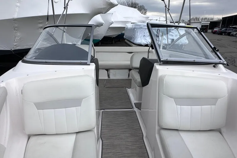 Slide: The Image of 2018 Regal 1900 ES Bowrider interior with white seating and dual windshields. - 21