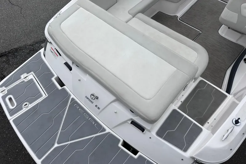 Slide: The Image of 2018 Regal 1900 ES Bowrider boat with gray deck and cushioned seating. - 6