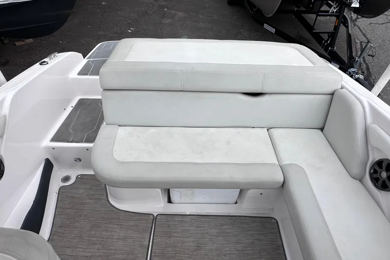 Slide: The Image of 2018 Regal 1900 ES Bowrider interior seating with gray upholstery and speaker detail. - 8