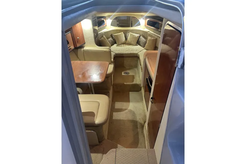Slide: The Image of Interior of 2007 Sea Ray Sundancer 280, featuring cozy seating and wooden table. - 12