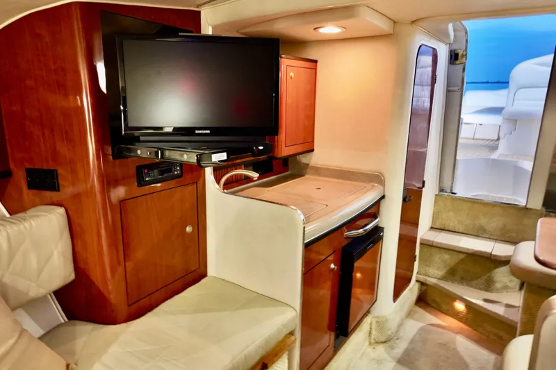 Slide: The Image of 2007 Sea Ray Sundancer 280 interior with TV, kitchenette, and seating area. - 13