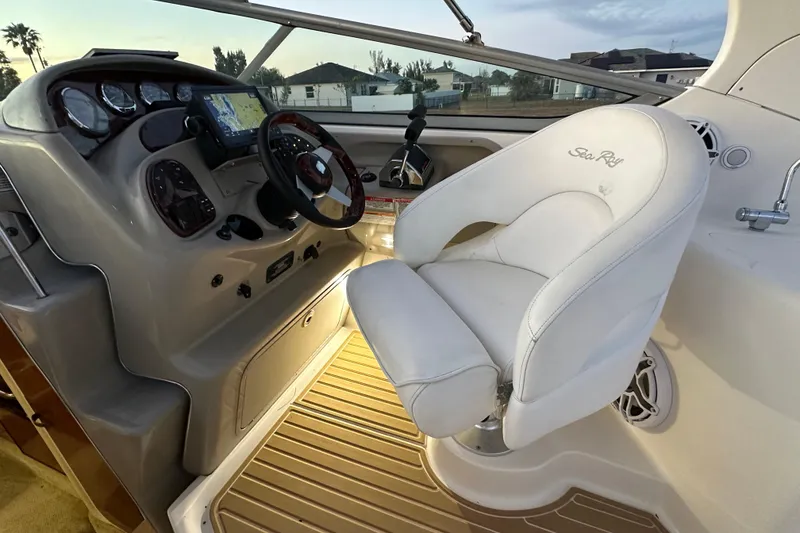 Slide: The Image of Captain's seat and dashboard of 2007 Sea Ray Sundancer 280 boat, featuring navigation controls. - 14