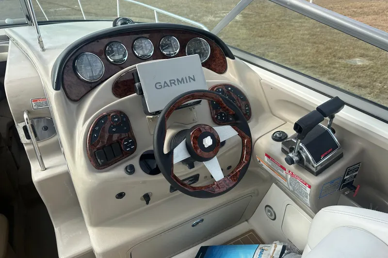 Slide: The Image of 2007 Sea Ray Sundancer 280 helm with Garmin navigation and wood-accented steering wheel. - 16