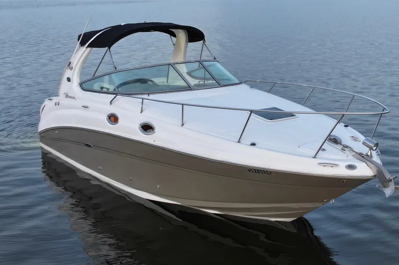 Slide: The Image of 2007 Sea Ray Sundancer 280 boat on calm water, featuring sleek design and white exterior. - 2