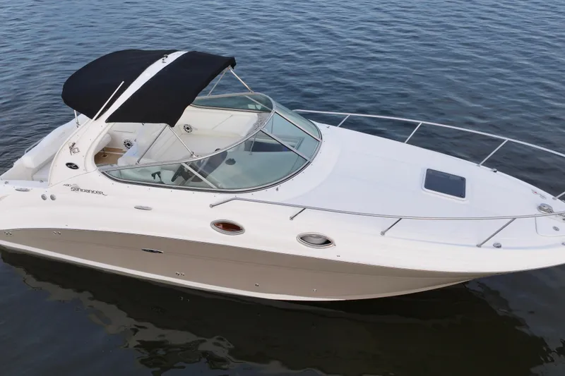 Slide: The Image of 2007 Sea Ray Sundancer 280 boat with black canopy on calm water. - 3