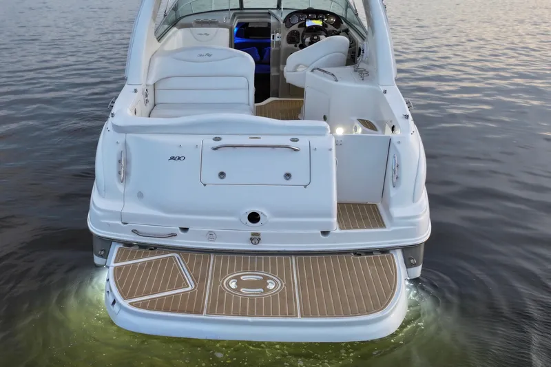 Slide: The Image of 2007 Sea Ray Sundancer 280 boat on water, rear view with illuminated deck. - 7