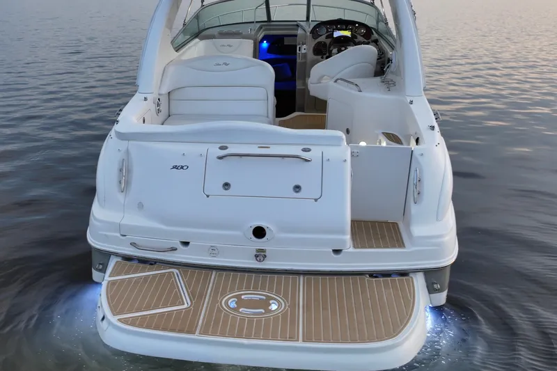 Slide: The Image of 2007 Sea Ray Sundancer 280 boat on calm water, rear view with illuminated deck. - 8