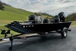 Slide: The Image of 2024 Tracker Bass Tracker Classic XL boat on trailer, parked on a paved road. - 10