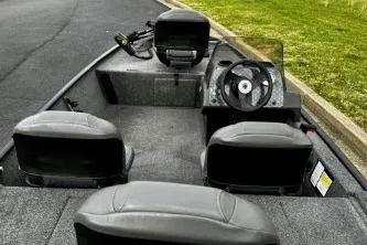 Slide: The Image of 2024 Tracker Bass Tracker Classic XL boat interior with steering wheel and seating. - 11
