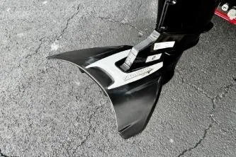 Slide: The Image of 2024 Tracker Bass Tracker Classic XL boat motor detail on asphalt surface. - 4