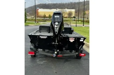 Slide: The Image of 2024 Tracker Bass Tracker Classic XL boat, rear view, parked outdoors. - 7