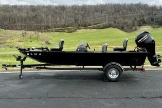Slide: The Image of 2024 Tracker Bass Tracker Classic XL boat on trailer, parked on asphalt with scenic background. - 9