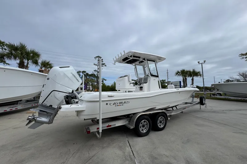 Slide: The Image of 2026 Caymas 26 HB boat on trailer, featuring a powerful Mercury outboard motor. - 10