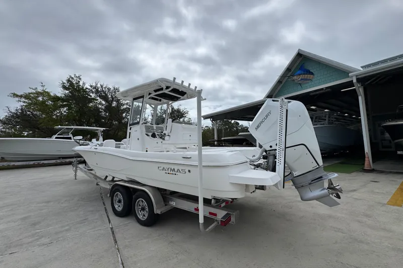 Slide: The Image of 2026 Caymas 26 HB boat on trailer with Mercury outboard motor. - 15