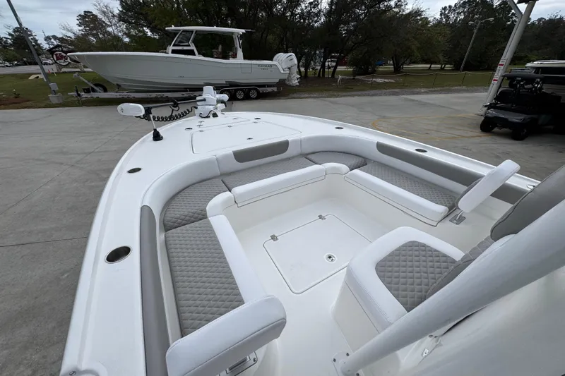 Slide: The Image of 2026 Caymas 26 HB boat with spacious seating and modern design in a marina setting. - 19