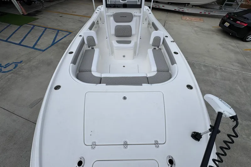 Slide: The Image of 2026 Caymas 26 HB boat with spacious seating and modern design in a parking area. - 21