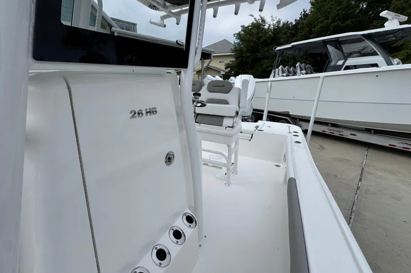 Slide: The Image of 2026 Caymas 26 HB boat interior with seating and console details. - 24