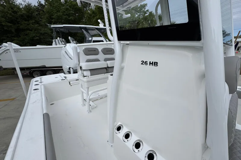 Slide: The Image of 2026 Caymas 26 HB boat interior with seating and console details. - 25