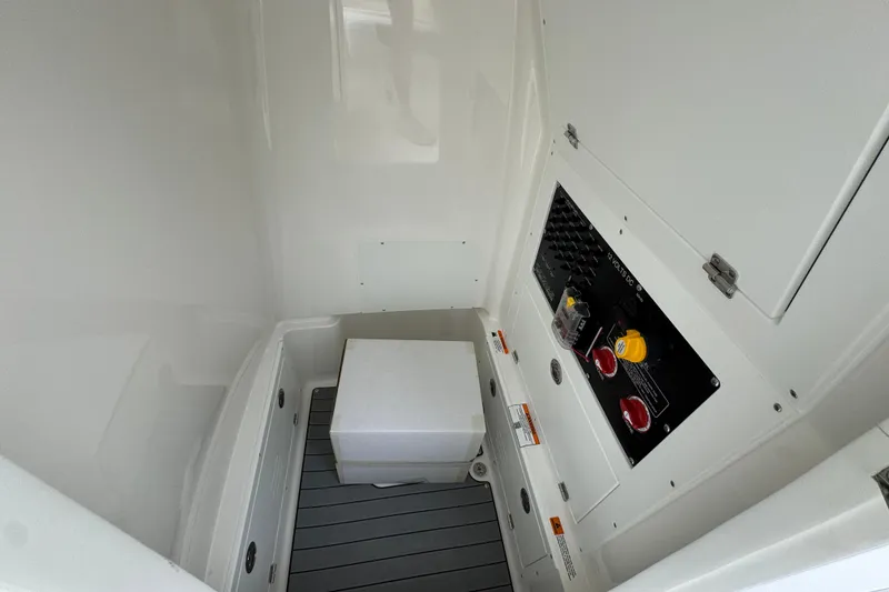 Slide: The Image of Interior view of 2026 Caymas 26 HB boat compartment with control panel and storage. - 26
