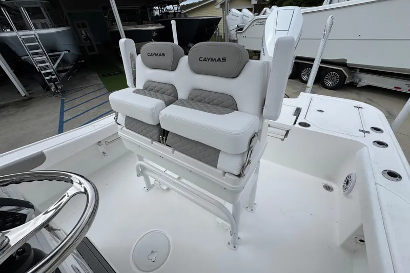 Slide: The Image of 2026 Caymas 26 HB boat interior with dual cushioned seats and steering wheel. - 27