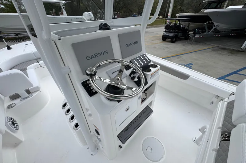 Slide: The Image of Steering console of 2026 Caymas 26 HB boat with Garmin displays and Mercury controls. - 31