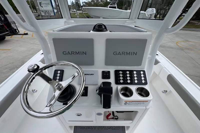 Slide: The Image of 2026 Caymas 26 HB boat dashboard with Garmin displays and steering wheel. - 32