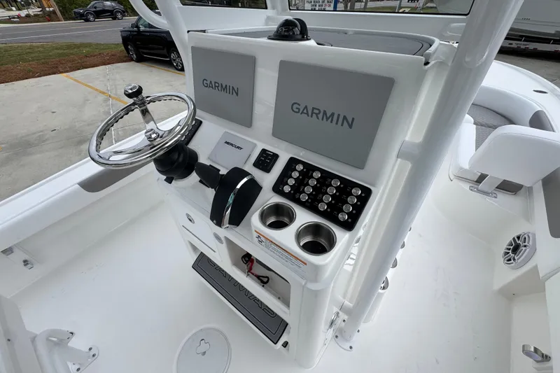 Slide: The Image of 2026 Caymas 26 HB boat console with Garmin displays and steering wheel. - 34
