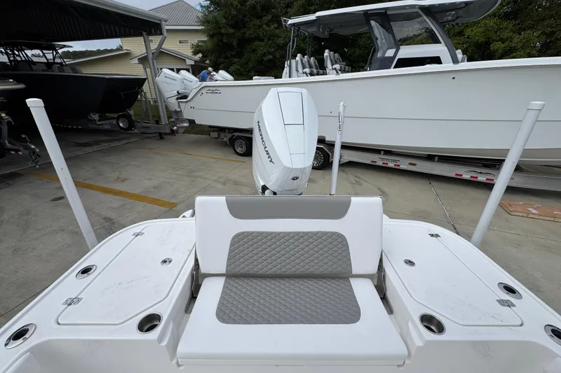 Slide: The Image of 2026 Caymas 26 HB boat with Mercury engine, parked in a marina. - 38