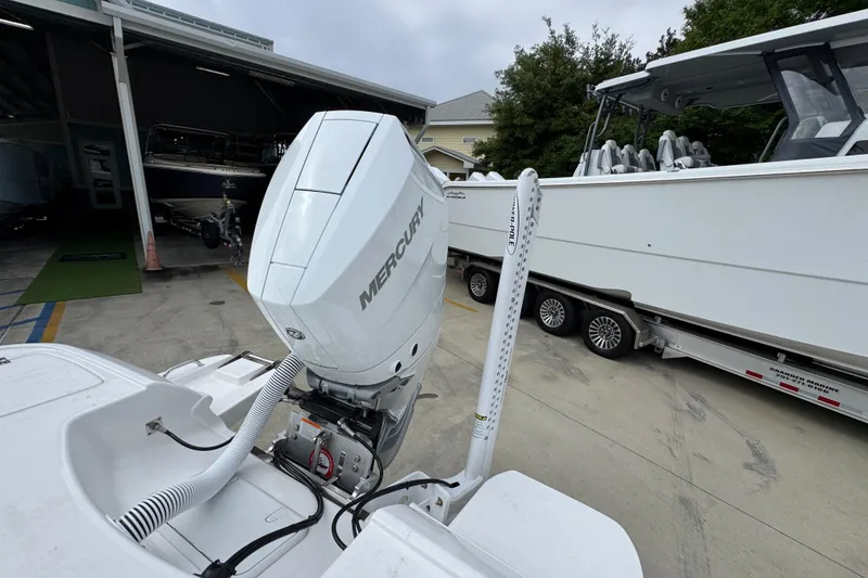 Slide: The Image of 2026 Caymas 26 HB boat with Mercury outboard engine in a marina setting. - 39