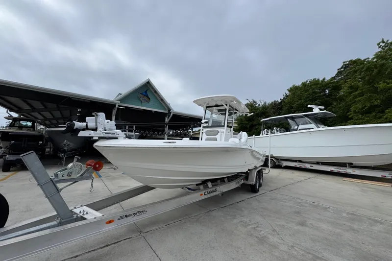 Slide: The Image of 2026 Caymas 26 HB boat on trailer, parked outdoors under cloudy sky. - 4