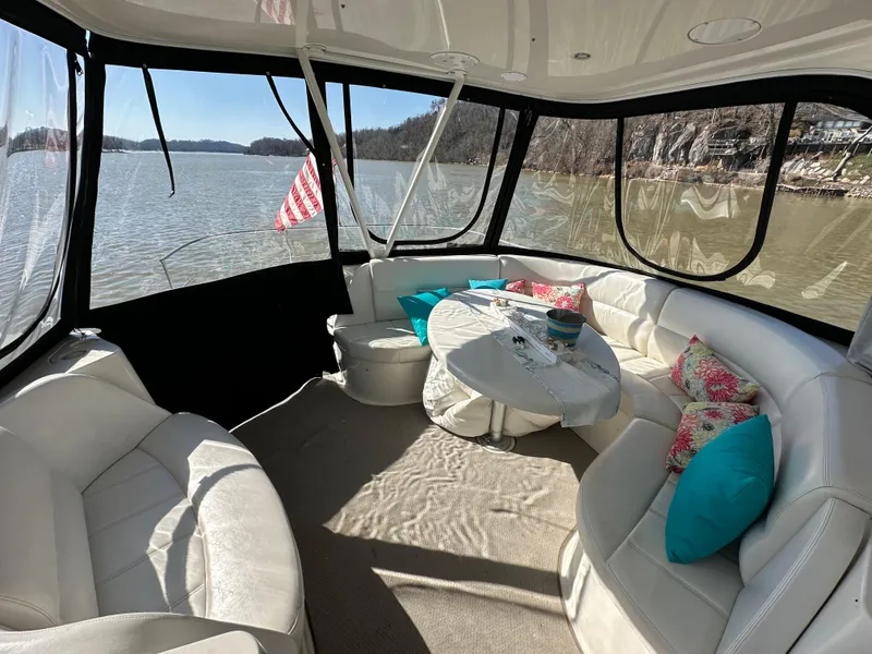 Slide: The Image of Luxurious 2005 Carver 56 Voyager yacht interior with plush seating and scenic lake view. - 10