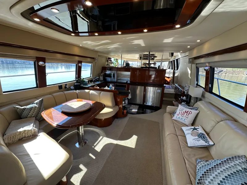 Slide: The Image of Luxurious interior of a 2005 Carver 56 Voyager yacht with elegant seating and modern amenities. - 13