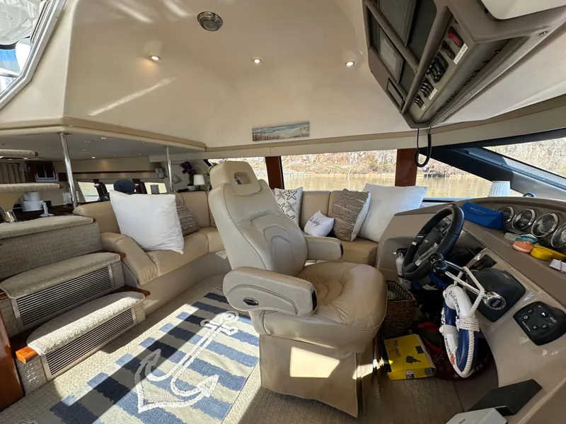 Slide: The Image of Luxurious interior of a 2005 Carver 56 Voyager yacht with plush seating and modern controls. - 14