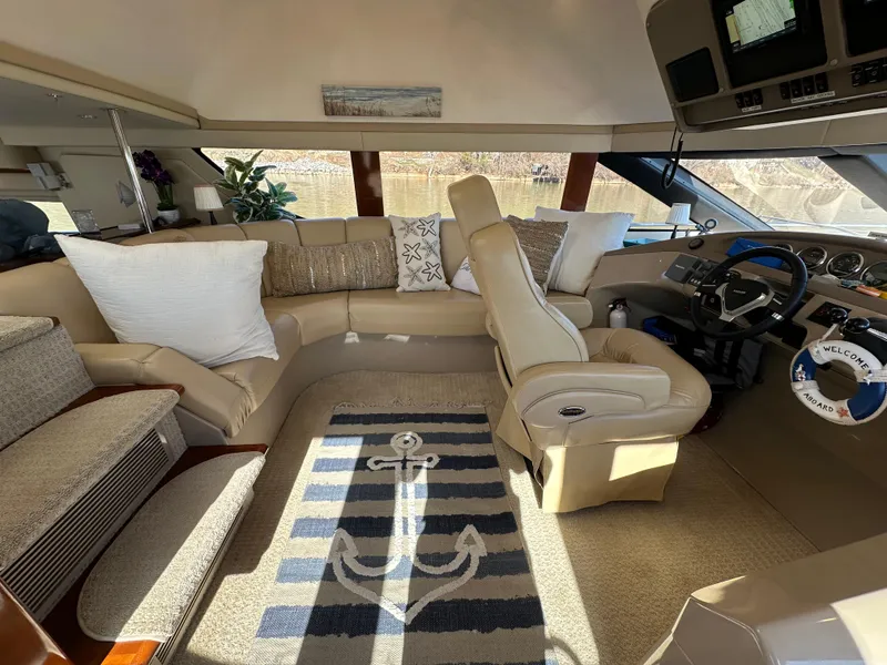 Slide: The Image of Luxurious interior of 2005 Carver 56 Voyager yacht with plush seating and nautical decor. - 16