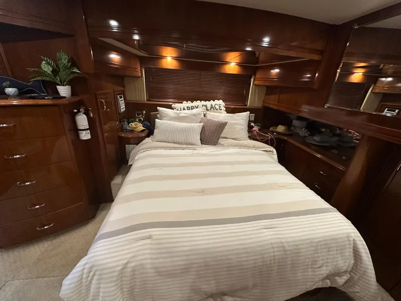 Slide: The Image of Luxurious bedroom interior of 2005 Carver 56 Voyager yacht with cozy bedding. - 17