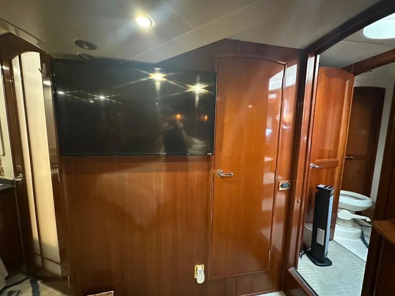 Slide: The Image of Interior of 2005 Carver 56 Voyager yacht with wood paneling and mounted TV. - 20