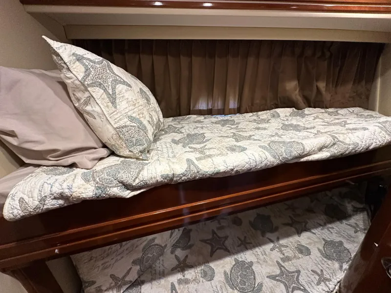 Slide: The Image of Bunk beds with starfish-themed bedding in a 2005 Carver 56 Voyager yacht. - 21
