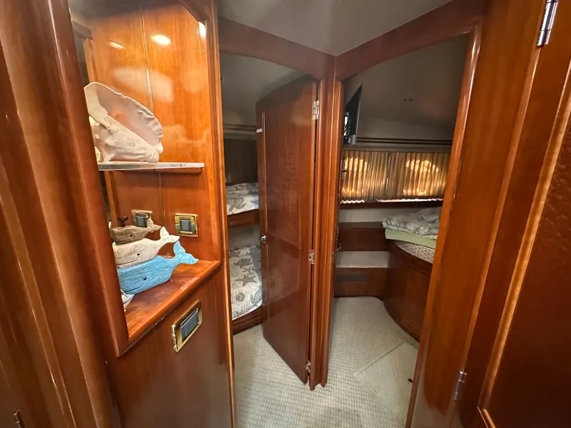 Slide: The Image of Interior of 2005 Carver 56 Voyager yacht with wooden cabinetry and cozy sleeping quarters. - 22