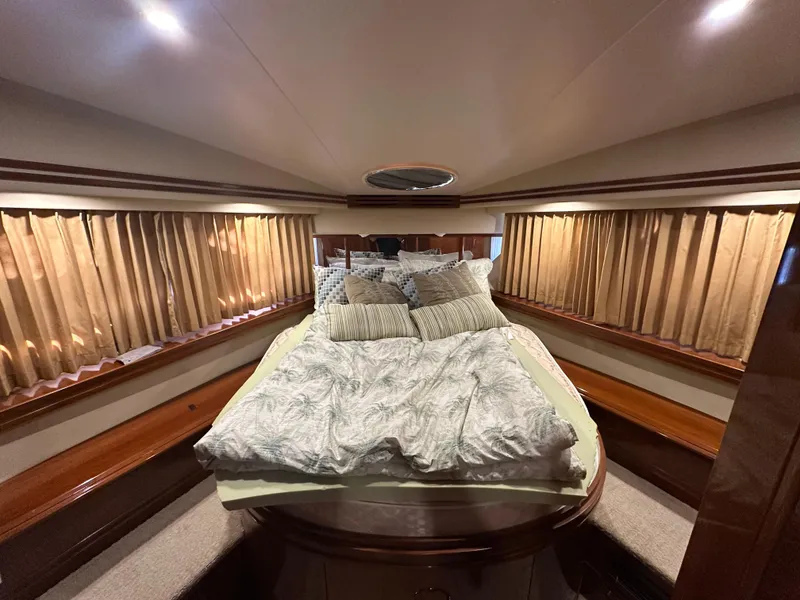 Slide: The Image of Luxurious bedroom interior of 2005 Carver 56 Voyager yacht with elegant bedding. - 23