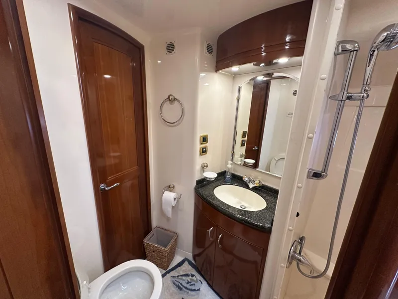 Slide: The Image of Luxurious bathroom in 2005 Carver 56 Voyager yacht with modern fixtures and wood accents. - 24
