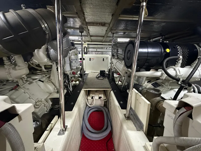 Slide: The Image of Engine room of 2005 Carver 56 Voyager yacht, showcasing mechanical components and equipment. - 25